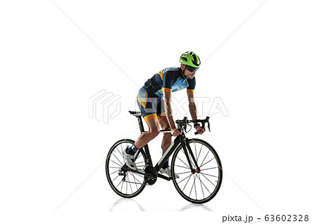 Triathlon male athlete cycle training isolated on white studio background Triathlon male athlete cycle training isolated on white studio background 63602328