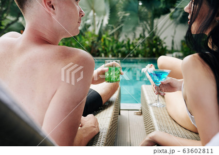 Young couple drinking tasty refreshing cocktails 63602811