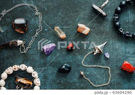 Magic flat lay. Various precious and semiprecious stones on a blue background for witchcraft. 63604290