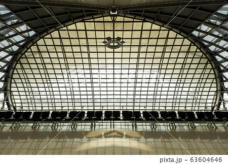 Clean airport waiting area interior with seats and windows. Clean airport waiting area interior with seats and windows. 63604646