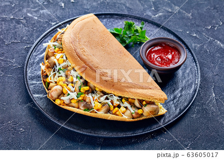 Turnover pancake with corn, cheese, and mushrooms Turnover pancake with corn, cheese, and mushrooms 63605017