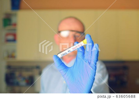 Doctor holds COVID 19 Coronavirus vaccine in his hand, infected sample in the sample tube, Vaccine and syringe injection It use for prevention, immunization and treatment from COVID-19. Doctor holds COVID 19 Coronavirus vaccine in his hand, infected sample in the sample tube, Vaccine and syringe injection It use for prevention, immunization and treatment from COVID-19. 63605688