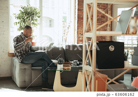 African-american man, freelancer during the work in home office while quarantine African-american man, freelancer during the work in home office while quarantine 63606162