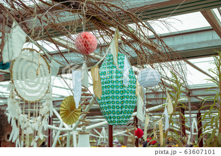 Paper lanterns and a dream catcher hang for decor at a market Paper lanterns and a dream catcher hang for decor at a market 63607101