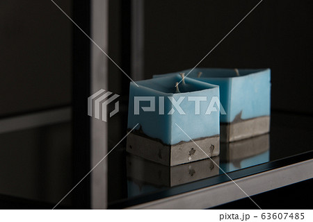 blue candle on a concrete base 63607485