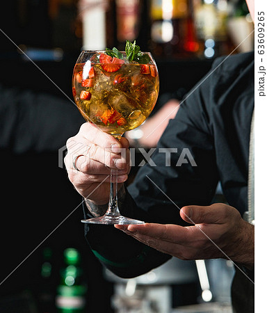 bartender making refreshing coctail with 63609265