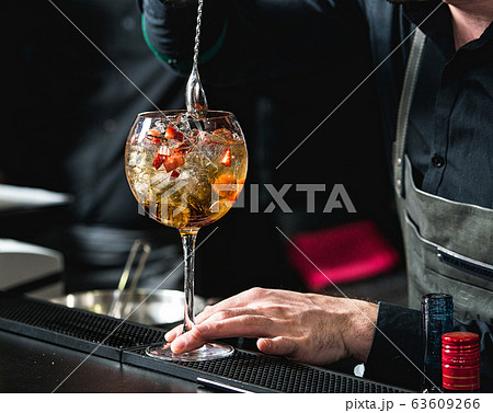 bartender making refreshing coctail with 63609266