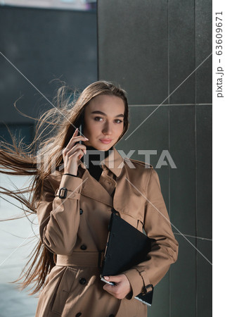 Self-confidence young business woman with file in Self-confidence young business woman with file in 63609671