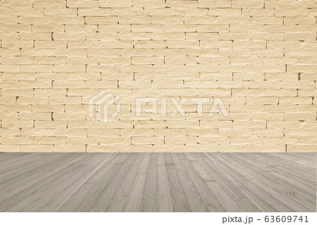 Grunge brick wall painted in light yellow beige with wooden floor in sepia brown with vignette for interior backgrounds 63609741
