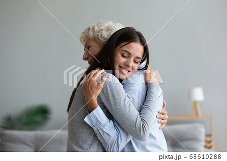 Happy senior mother and grown-up daughter hugging at home Happy senior mother and grown-up daughter hugging at home 63610288