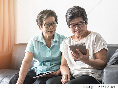 Aging society concept with elderly senior adult using mobile tablet technology for social network  63610384