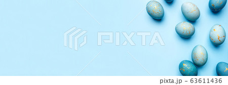 Easter frame of eggs painted in blue color. 63611436