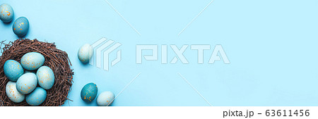 Easter eggs in nest on blue background. 63611456