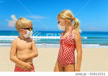 Two young children wearing sunglasses, protective Two young children wearing sunglasses, protective 63612551