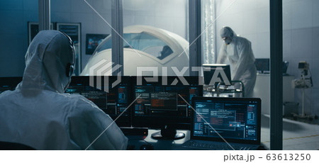 Engineers working in clean room Engineers working in clean room 63613250