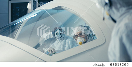 Engineers working in clean room Engineers working in clean room 63613266