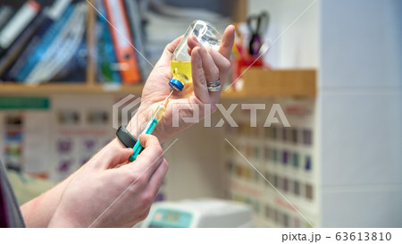 preparing for injection in doctor's office. vaccination against diseases preparing for injection in doctor's office. vaccination against diseases 63613810