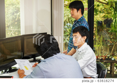 Programmers team working in a software developing. 63616274