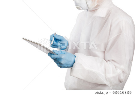 Doctor in anti-epidemic suit making notes on 63616339