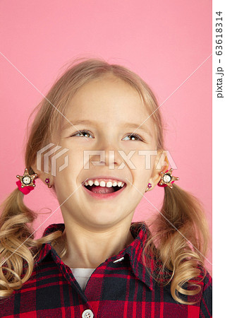 Caucasian little girl's close up portrait on pink studio background 63618314