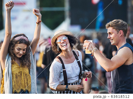 Group of young friends at summer festival, having good time. 63618512