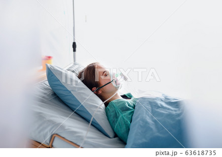 Infected patient in quarantine lying in bed in hospital, coronavirus concept. 63618735