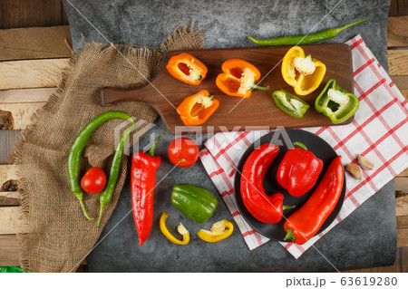 Seasonal vegetables on a piece of wood and stone pieces. Top view. Seasonal vegetables on a piece of wood and stone pieces. Top view. 63619280