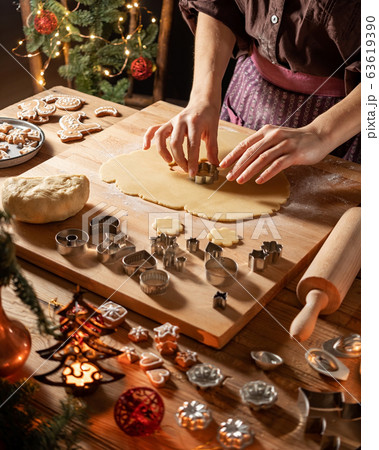 Woman cutting out star shapes for traditional Linzer cookies 63619390