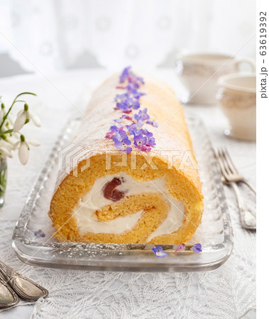Swiss roll filled with whipped cream and strawberries 63619392