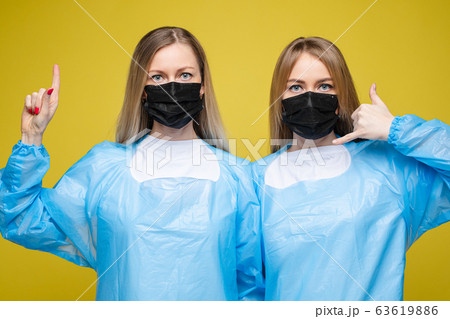 Young beautiful girls in a disposable medical Young beautiful girls in a disposable medical 63619886