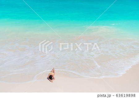 Young woman in bikinin on the beach Young woman in bikinin on the beach 63619898