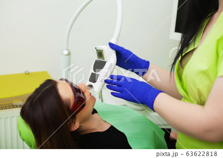 Pretty young girl at a reception in the dental office Pretty young girl at a reception in the dental office 63622818