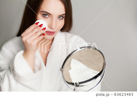 Pretty girl wipes the face after taking a shower sponge Pretty girl wipes the face after taking a shower sponge 63623465