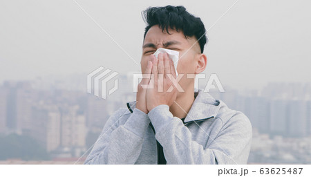man has allergy and sneeze 63625487