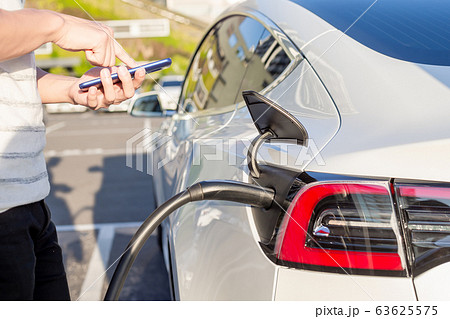 man Charges electric car 63625575