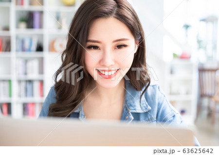 student using laptop at home 63625642