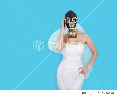 Bride in veil dress and protective mask in a gasの写真素材