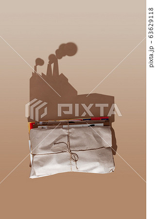 A stack of waste paper casts a hard shadow in the form of a garbage recycling plant. A stack of waste paper casts a hard shadow in the form of a garbage recycling plant. 63629118