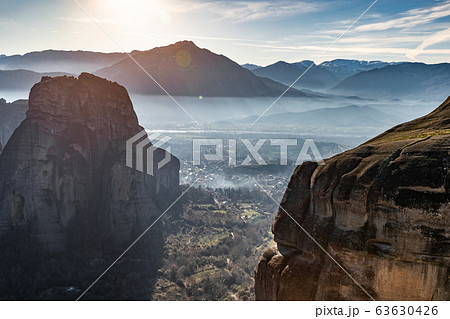 Aerial view of Unesco monument Meteora, the mountains, the landmark of Greek, sunny weather, fog, haze over a valley 63630426