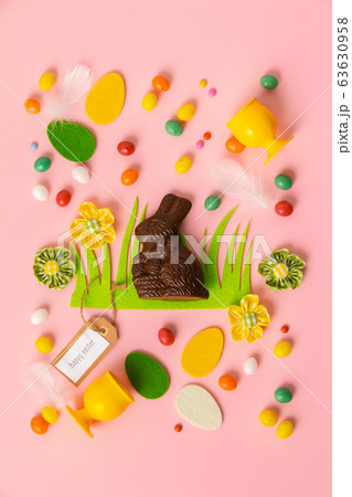 Felt Easter decorations and sweets on pink background Felt Easter decorations and sweets on pink background 63630958