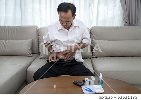 Asian old man test diabetes check and injec 63631135