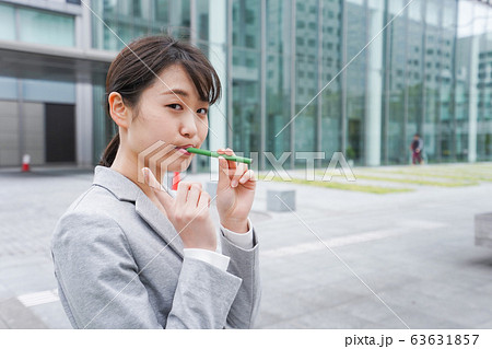電子タバコを吸う若いビジネスウーマン 63631857