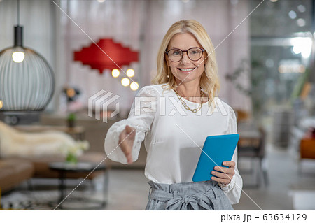 Successful woman in glasses held out her hand for dating. 63634129