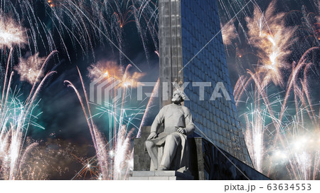 A statue of Konstantin Tsiolkovsky and Conquerors of Space Monument and fireworks, Moscow, Russia 63634553