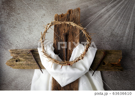 Easter background depicting the crucifixion with a rustic wooden cross, crown of thorns and nails. Easter background depicting the crucifixion with a rustic wooden cross, crown of thorns and nails. 63636610