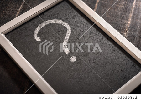 Chalk drawn question mark on a black board on a 63636852