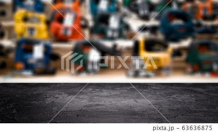 Black stone surface on blurry background in hardware store. 63636875