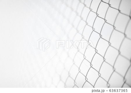 Close up rusty wire fence and blurred nature background. Wire netting or metal fence net and out of focus background. 63637365
