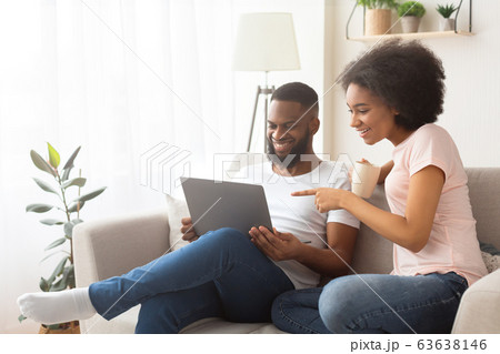 Couple happy to find a purchase in online store Couple happy to find a purchase in online store 63638146