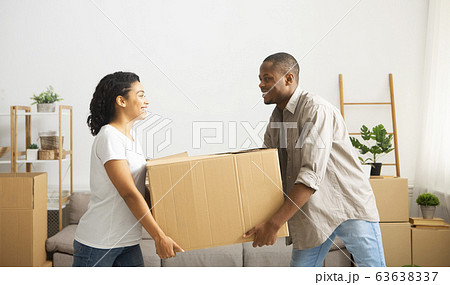 Couple carry out big box of home, make room for repairs Couple carry out big box of home, make room for repairs 63638337